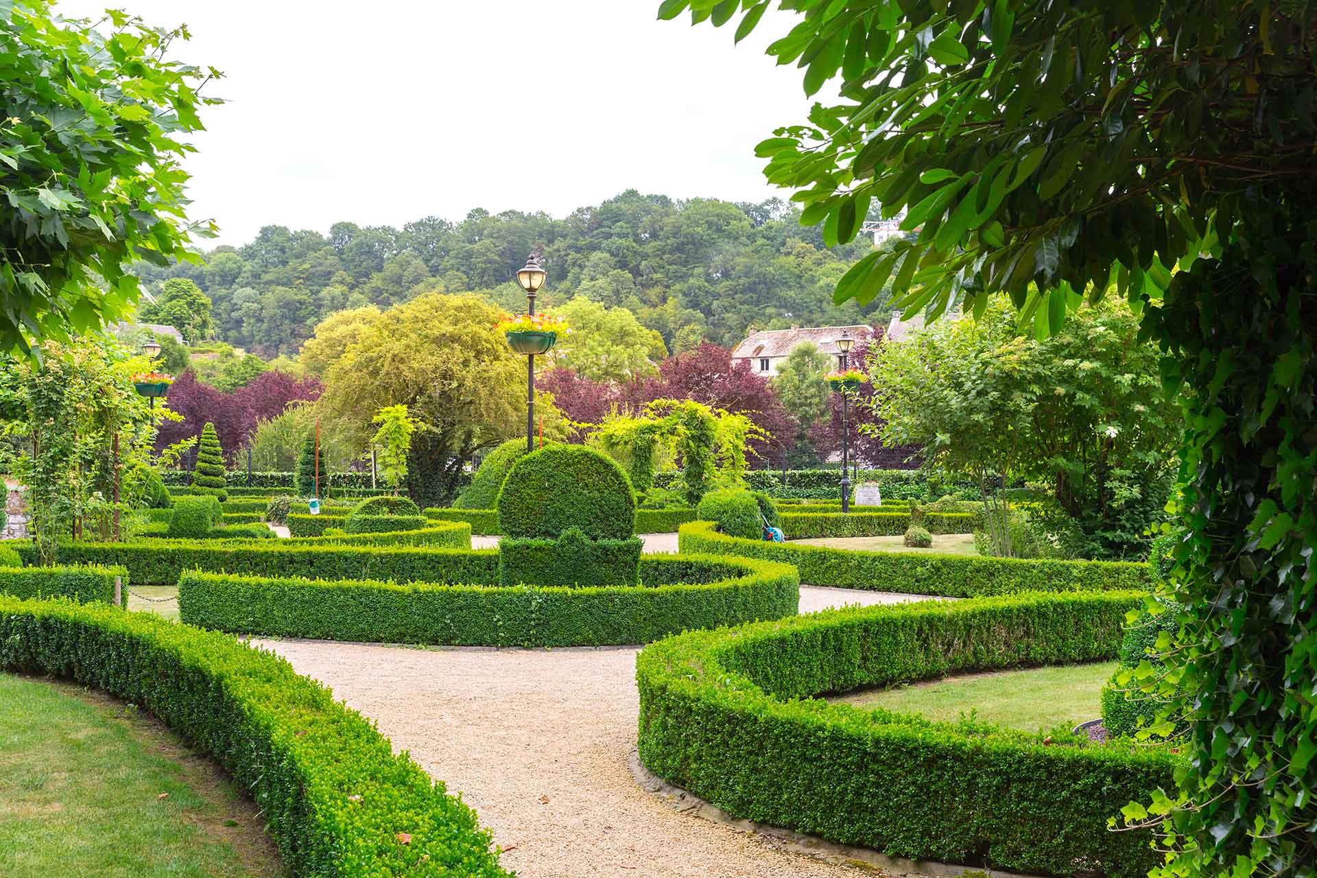 1. A circular garden featuring vibrant flowers and lush greenery, creating a serene and inviting outdoor space.